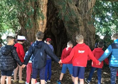 Singing the national anthem around the yew tree.