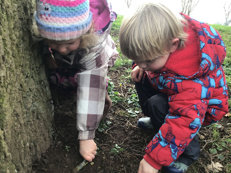 Nursery children exploring the natural environment