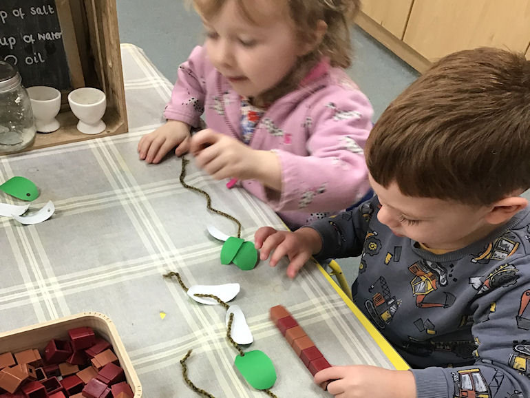 Nursery children making jewellery